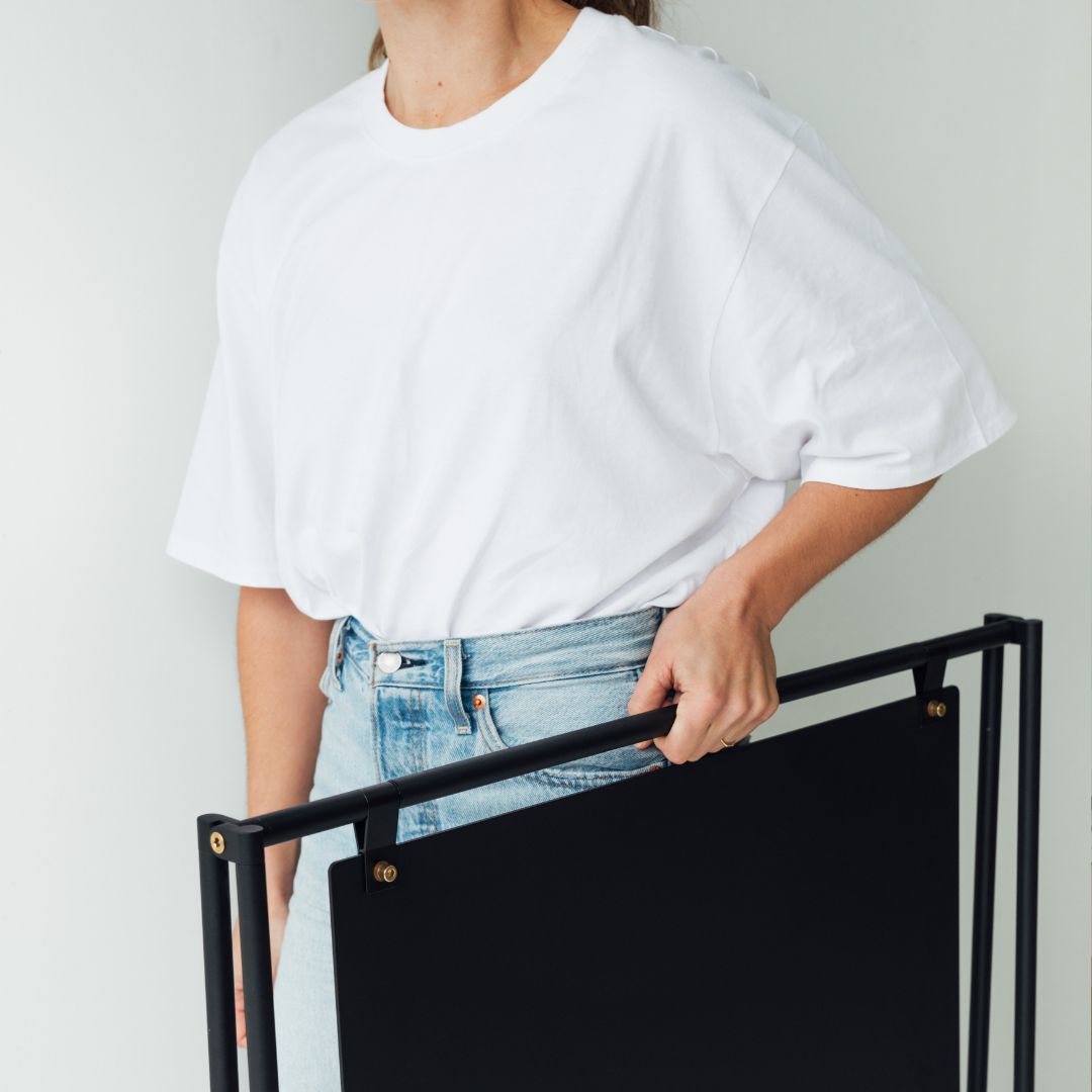 Large black a-frame sign being carried