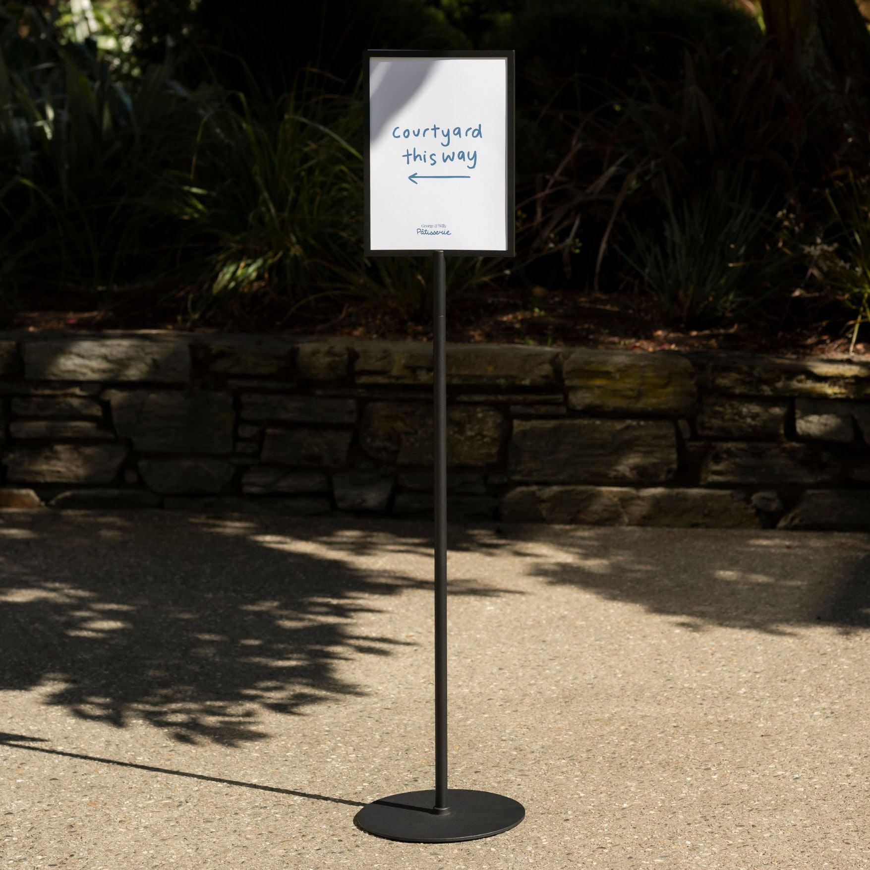 wayfinding sign stand outside on the pavement