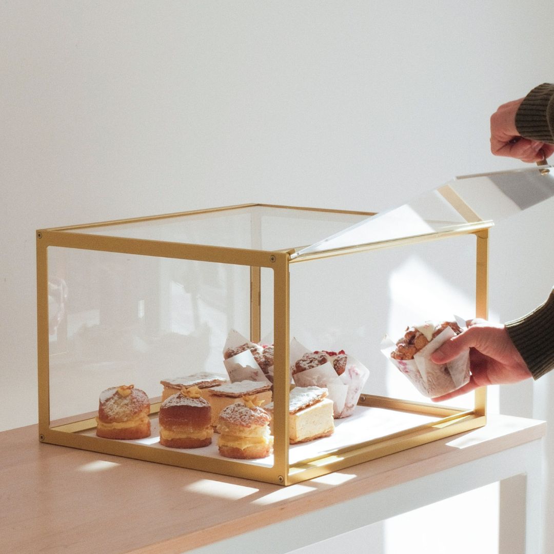 Small brass colored bakery display case