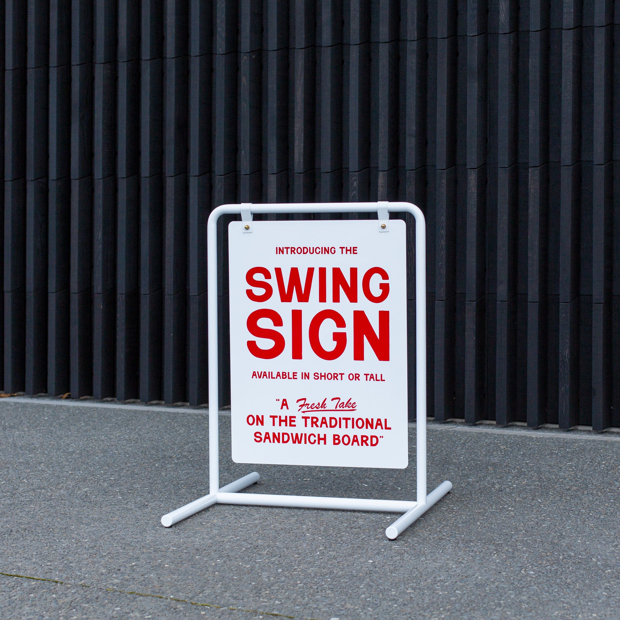 white customised swing sign on sidewalk